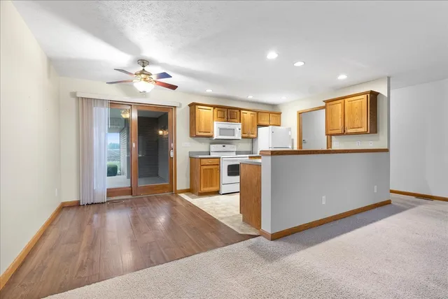 a view of a kitchen with a sink a refrigerator and a window