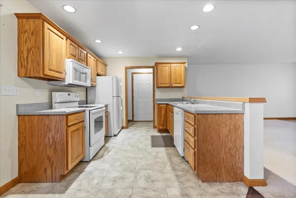a kitchen with stainless steel appliances granite countertop a stove a sink and a refrigerator