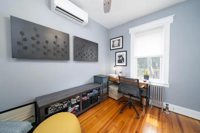 a workspace with lounge chair and a window