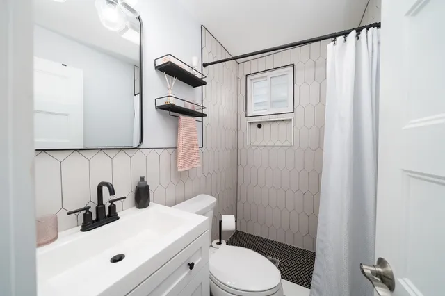 a view of a balcony with wooden floor and outdoor seating