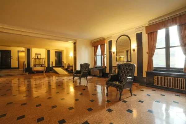 a living room with furniture fireplace and large windows