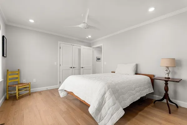 a bedroom with a bed and a chair