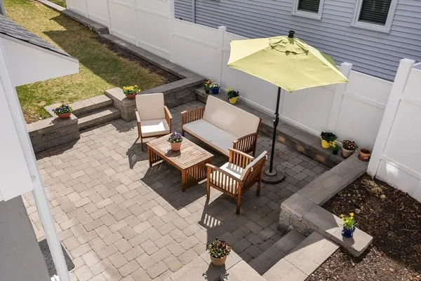 a balcony with table and chairs