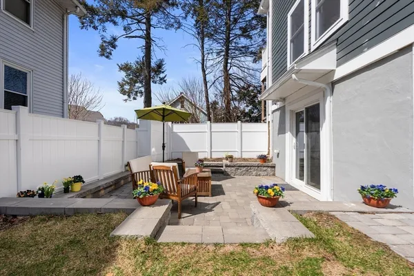 a view of a two chairs and table in the patio