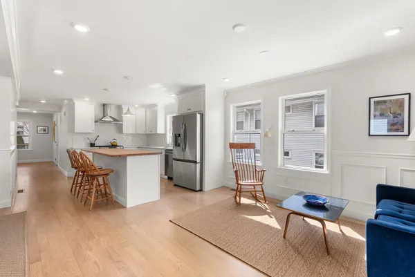a living room with furniture a dining table and kitchen view