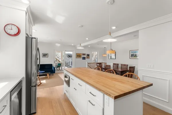 a large kitchen with a table and chairs