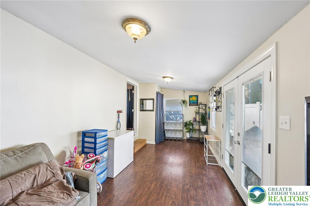 2649 Nottingham Road Bethlehem, PA 18017 - Photo 15 of 49 Natural light illuminates this versatile living space, featuring warm wood flooring and convenient French doors.