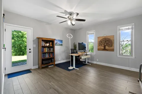 a view of a workspace with furniture and a window