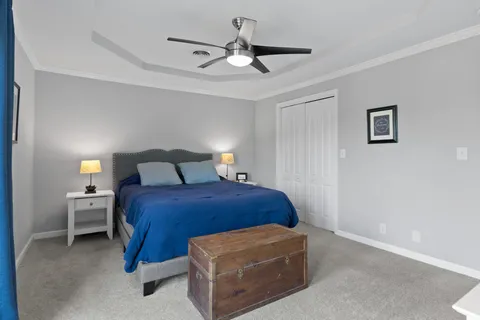 a bedroom with a bed and a chandelier