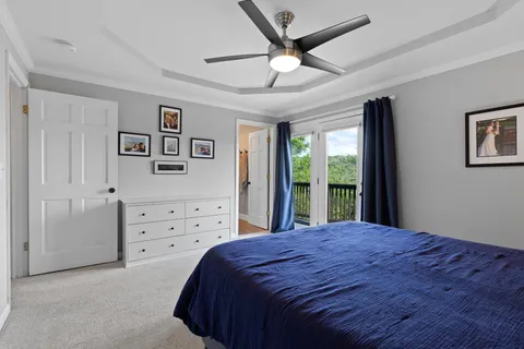 a bedroom with a large bed and a chandelier