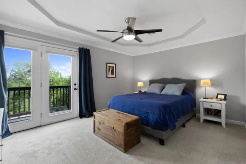 a bedroom with a bed and a large window