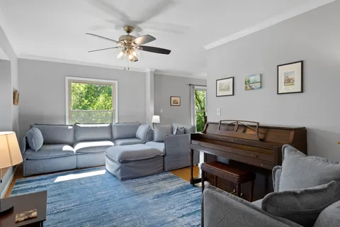 a living room with furniture and a chandelier
