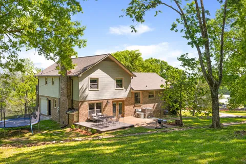 a view of a house with a yard balcony and sitting area