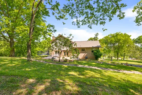 a backyard of a house with table and chairs