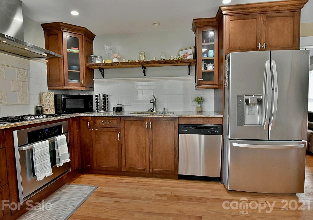 2087 Mission Road York, SC 29745 - Photo 11 of 30 a kitchen with stainless steel appliances granite countertop a refrigerator a stove and a sink with wooden cabinets