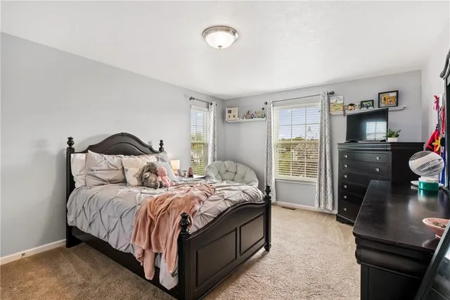 a bedroom with a bed and a dresser