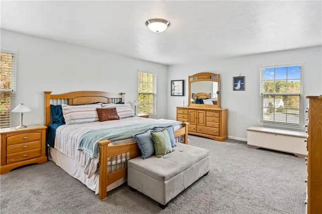 a bedroom with a bed couch and window