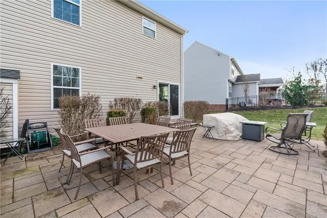 a view of a patio with table and chairs and potted plants