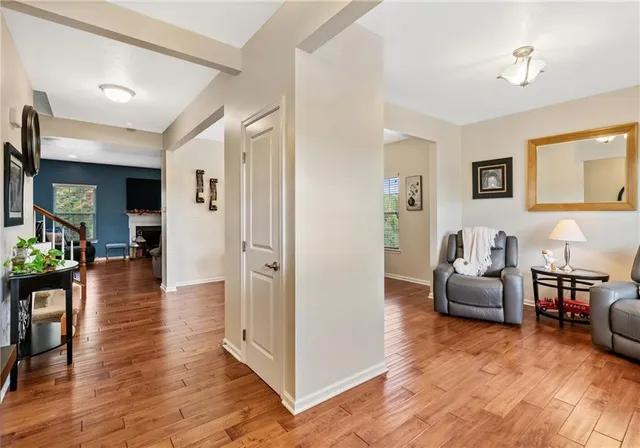 a living room with furniture and wooden floor