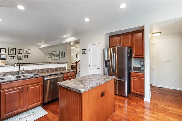 a kitchen with stainless steel appliances granite countertop a sink and stove