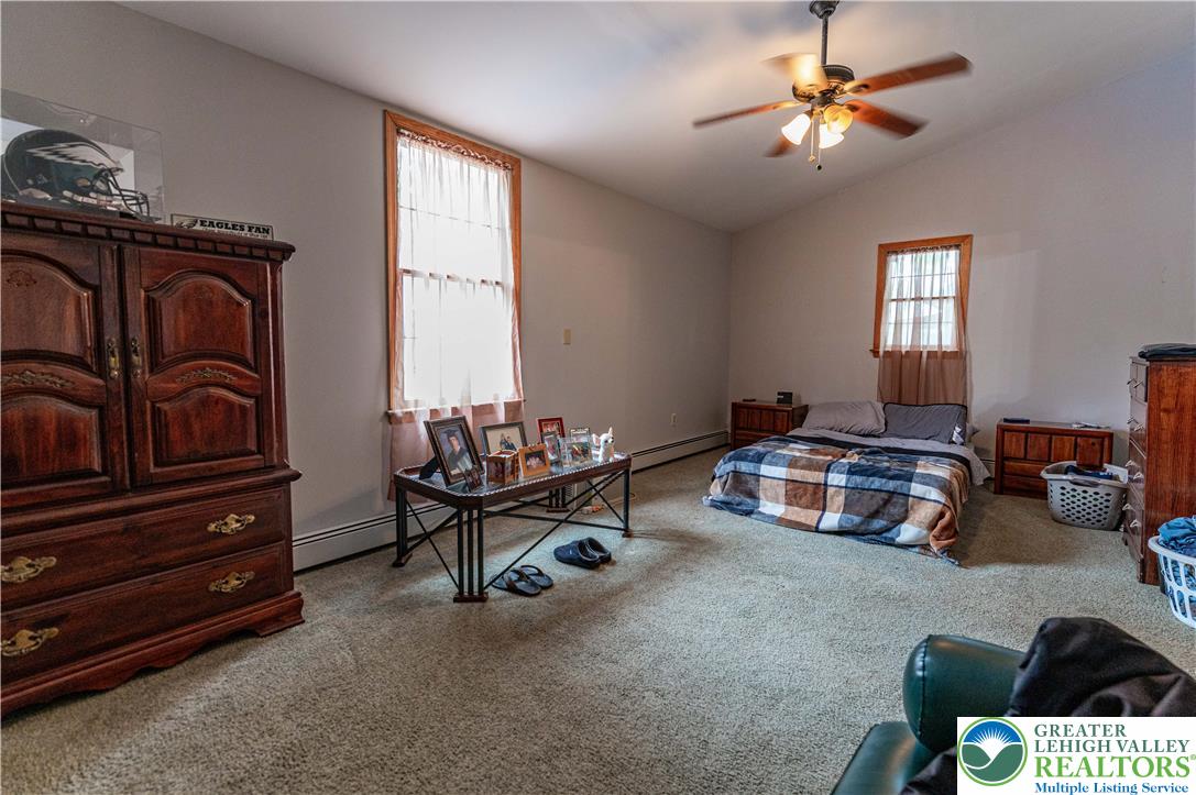 2485 Hieter Road Quakertown, PA 18951 - Photo 65 of 97 A comfortable bedroom features carpet flooring and a vaulted ceiling with a fan.