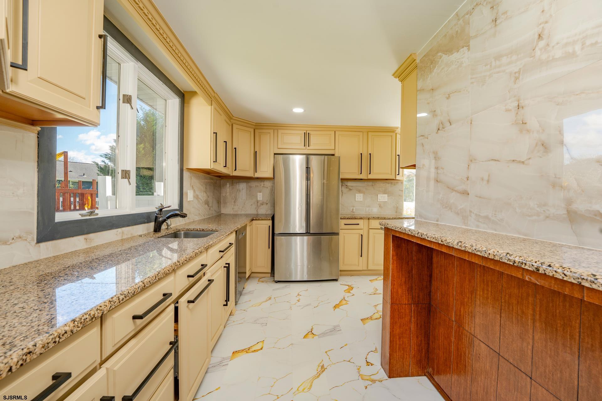1203 West Mill Road Northfield, NJ 08225 - Photo 13 of 90 a kitchen with stainless steel appliances granite countertop a granite counter tops and a refrigerator