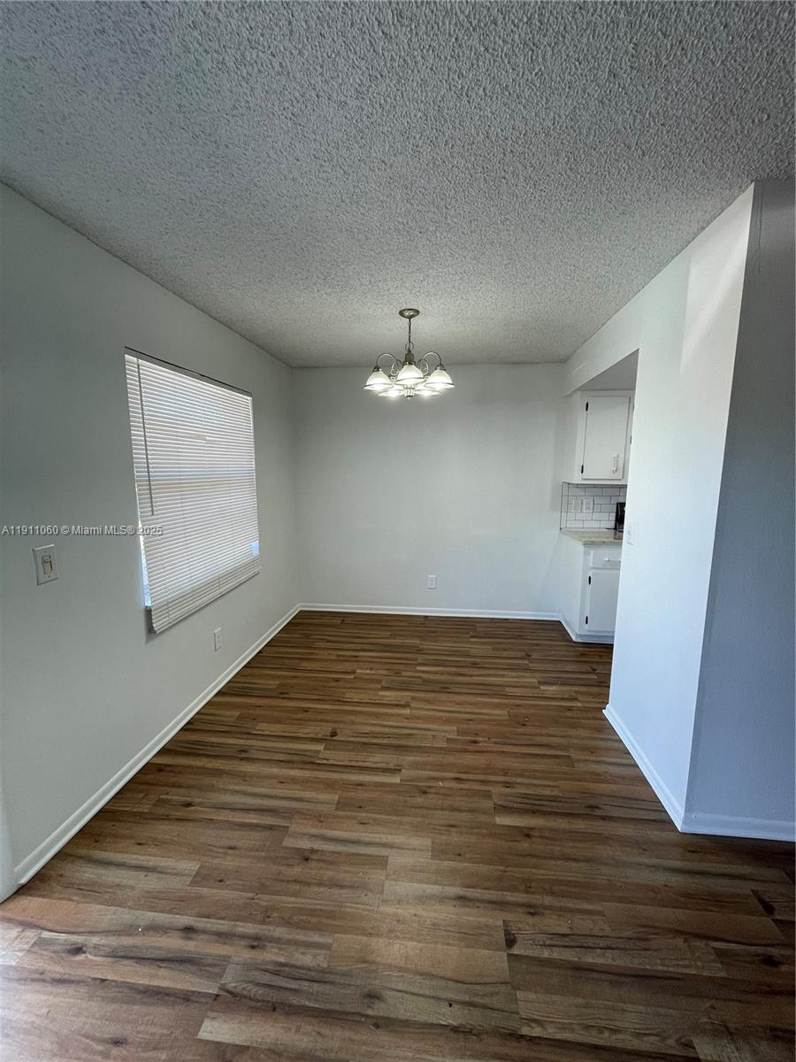 227 Castlewood Drive, Unit 102 North Palm Beach, FL 33408 - Photo 12 of 26 a view of empty room with wooden floor