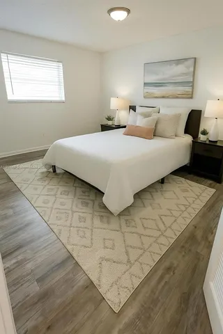 a bedroom with a bed and a night stand