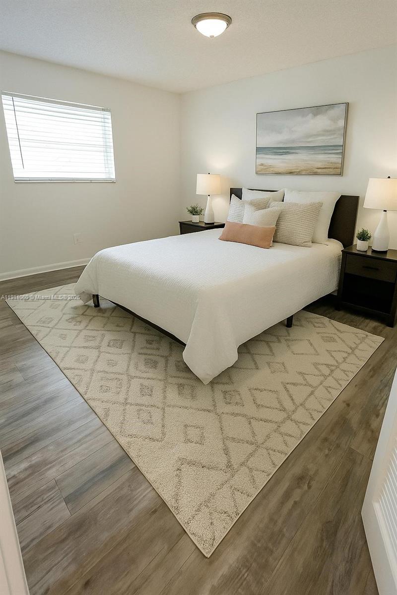 227 Castlewood Drive, Unit 102 North Palm Beach, FL 33408 - Photo 16 of 26 a bedroom with a bed and a night stand