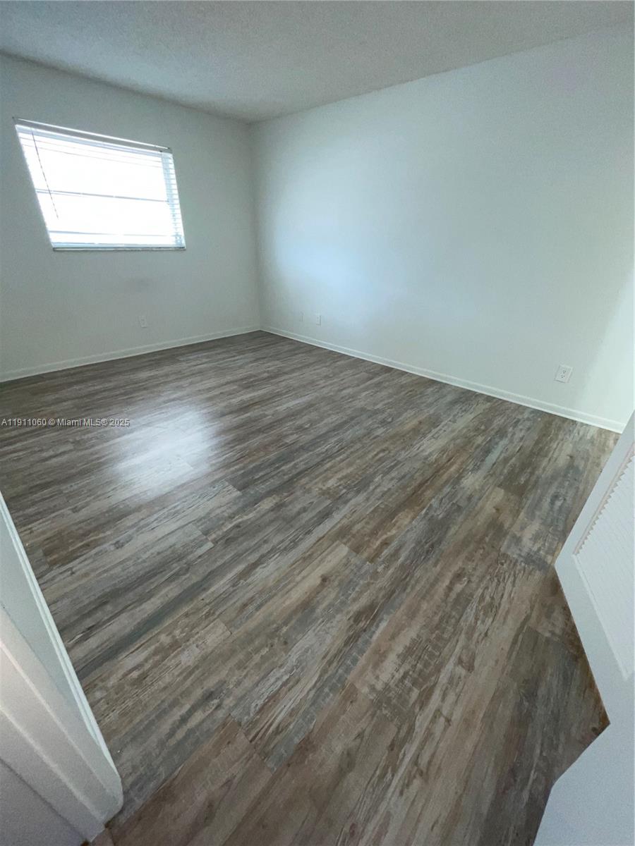 227 Castlewood Drive, Unit 102 North Palm Beach, FL 33408 - Photo 17 of 26 a view of an empty room and window