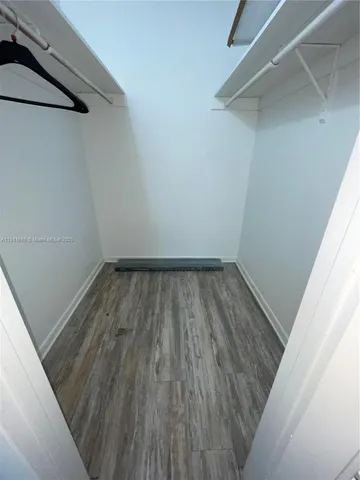 a view of wooden floor in a hallway