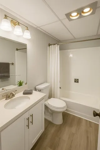 a bathroom with a double vanity sink toilet and shower