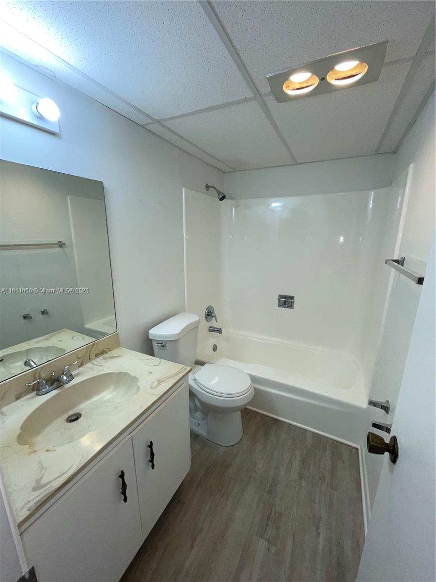 227 Castlewood Drive, Unit 102 North Palm Beach, FL 33408 - Photo 24 of 26 a bathroom with a granite countertop sink a toilet and shower