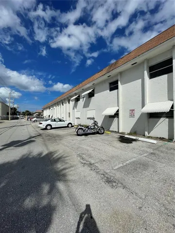 a view of a road with wooden fence