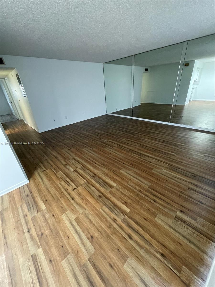 227 Castlewood Drive, Unit 102 North Palm Beach, FL 33408 - Photo 6 of 26 a view of a room with wooden floor