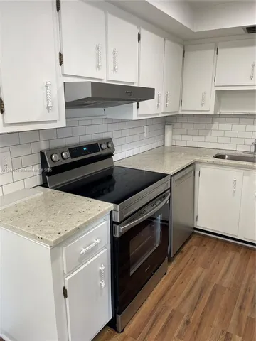 a kitchen with a stove and a sink