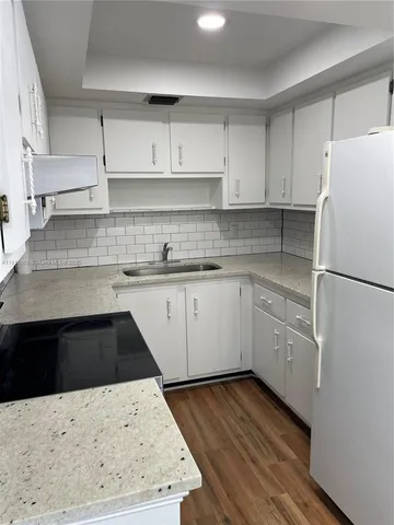 a kitchen with a sink a stove and refrigerator