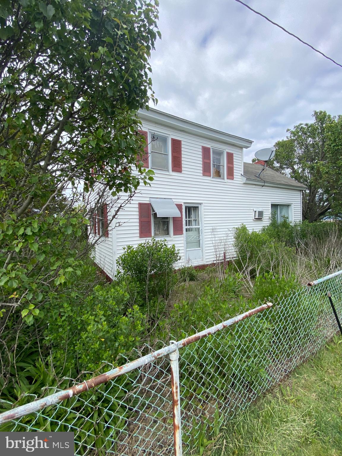 a view of a house with a yard and plants