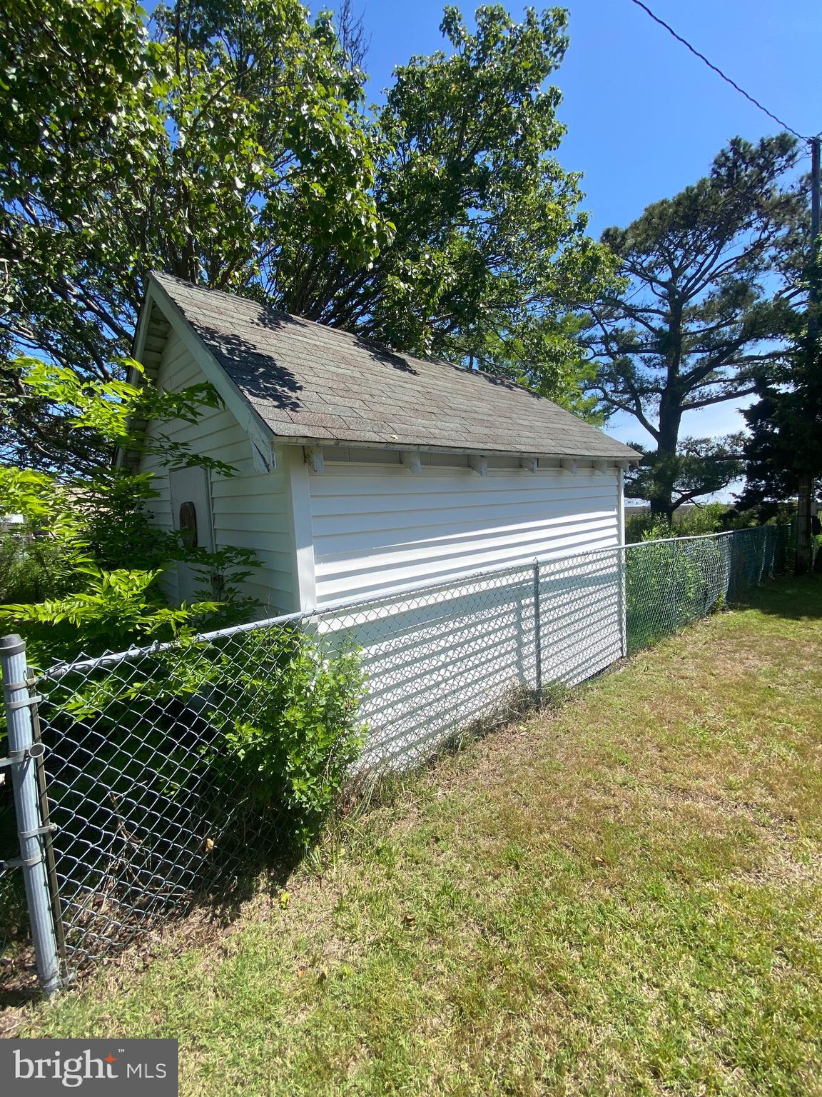 3251 Marsh Road Ewell, MD 21824 - Photo 11 of 23 a yellow house with trees in front of it