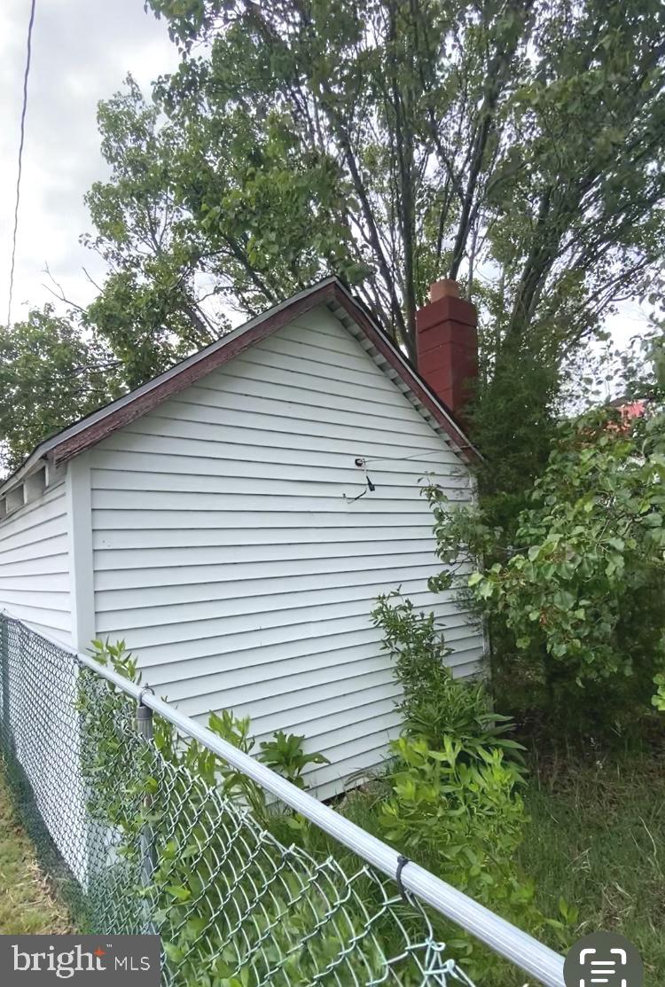 3251 Marsh Road Ewell, MD 21824 - Photo 12 of 23 a small white house with a white fence and plants