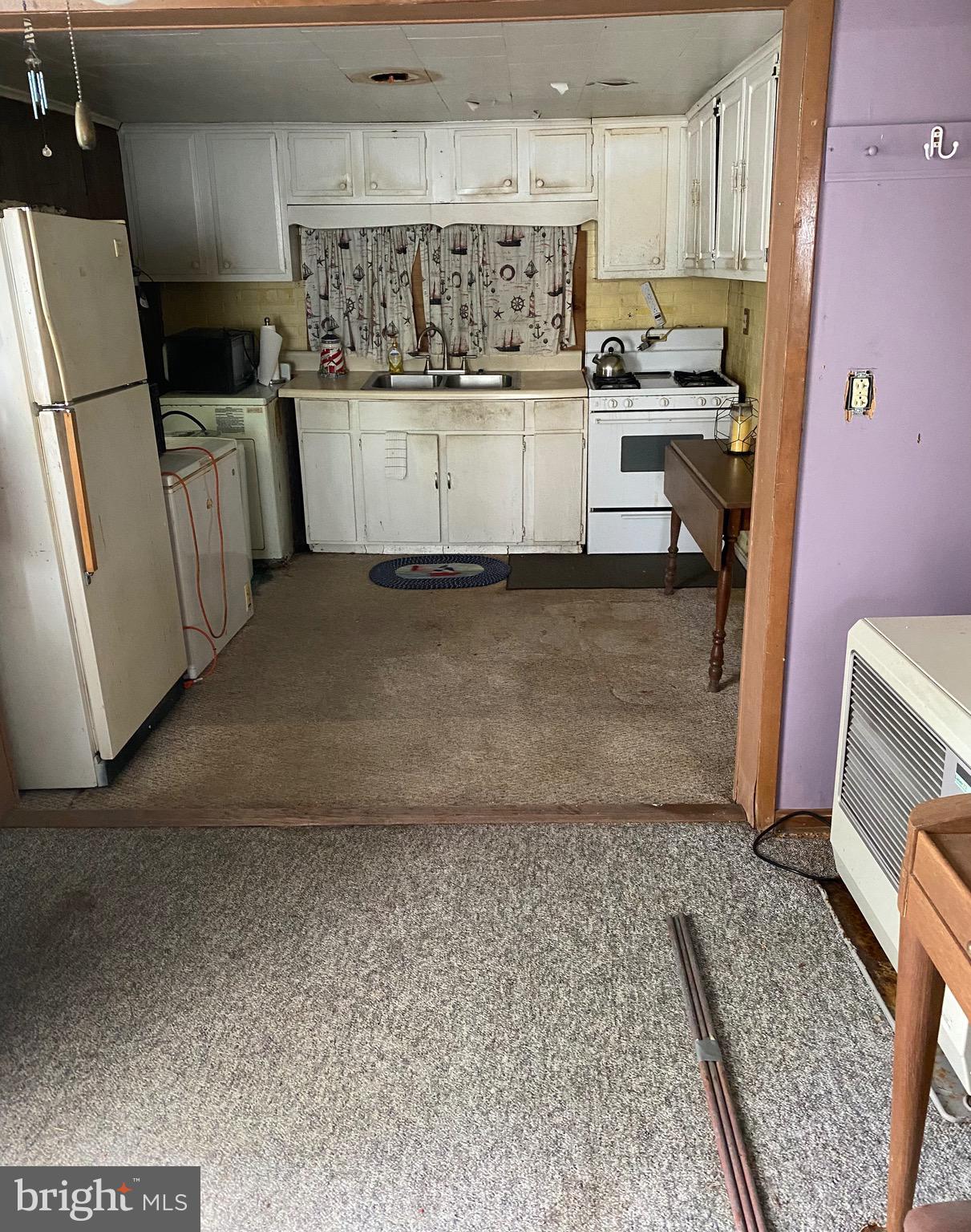 3251 Marsh Road Ewell, MD 21824 - Photo 13 of 23 a kitchen with white cabinets and refrigerator