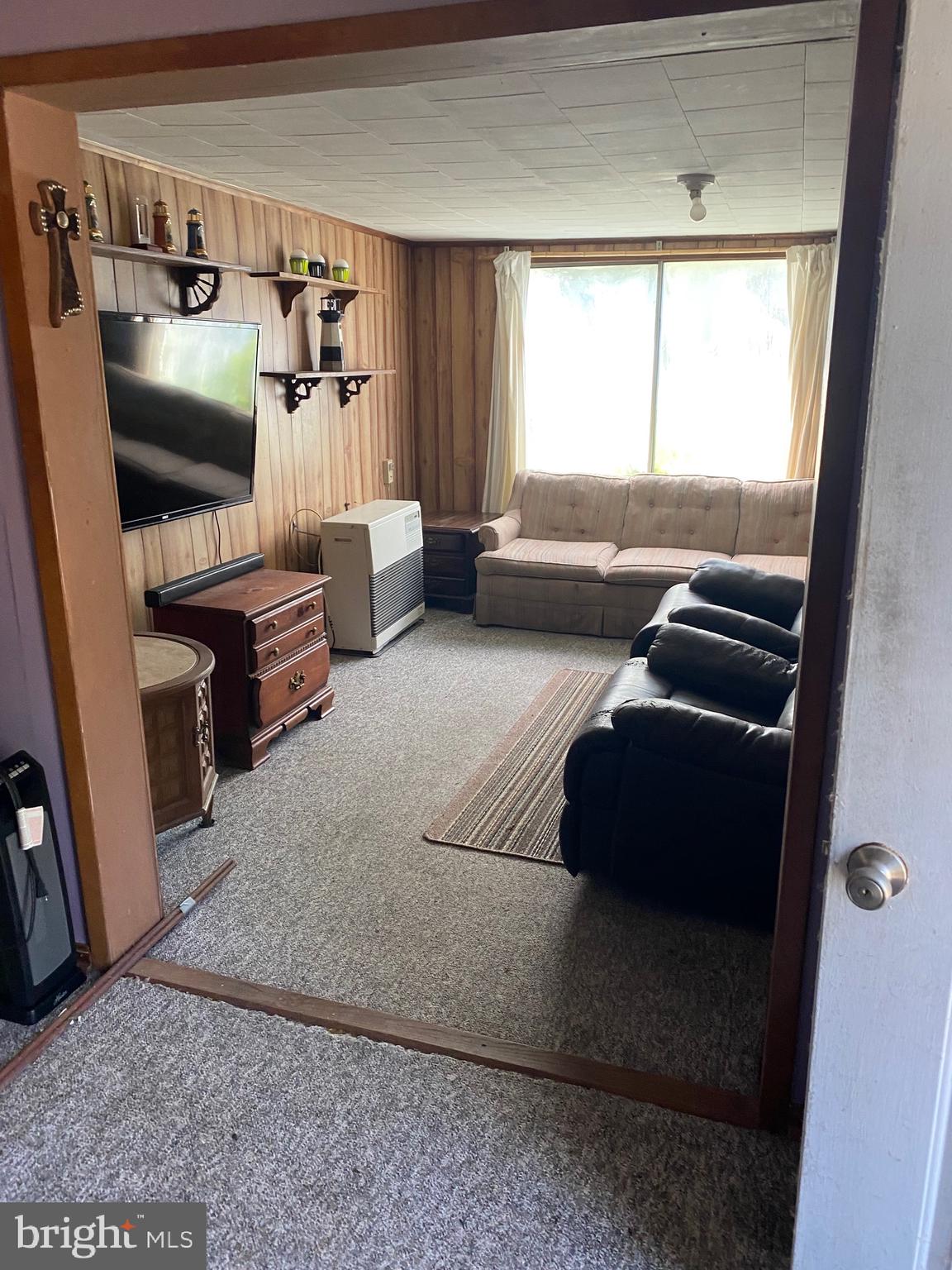 3251 Marsh Road Ewell, MD 21824 - Photo 15 of 23 a living room with furniture and a flat screen tv