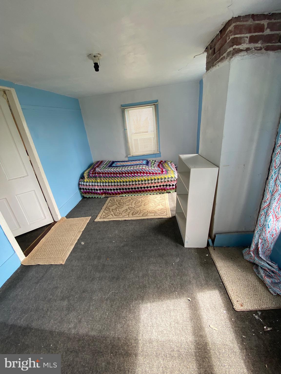3251 Marsh Road Ewell, MD 21824 - Photo 22 of 23 a room with a chair and white walls