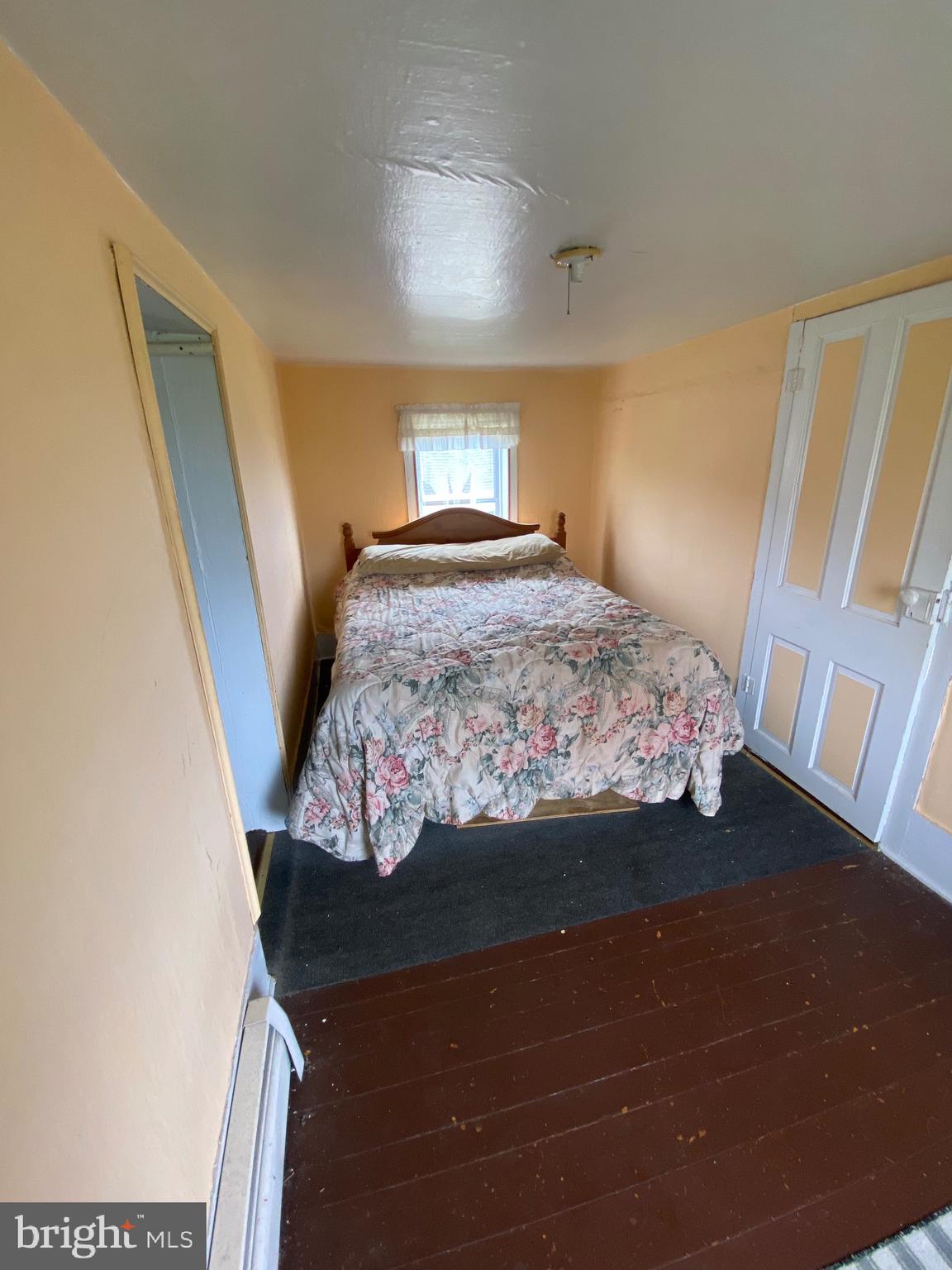 3251 Marsh Road Ewell, MD 21824 - Photo 25 of 32 a bedroom with a bed and a mirror
