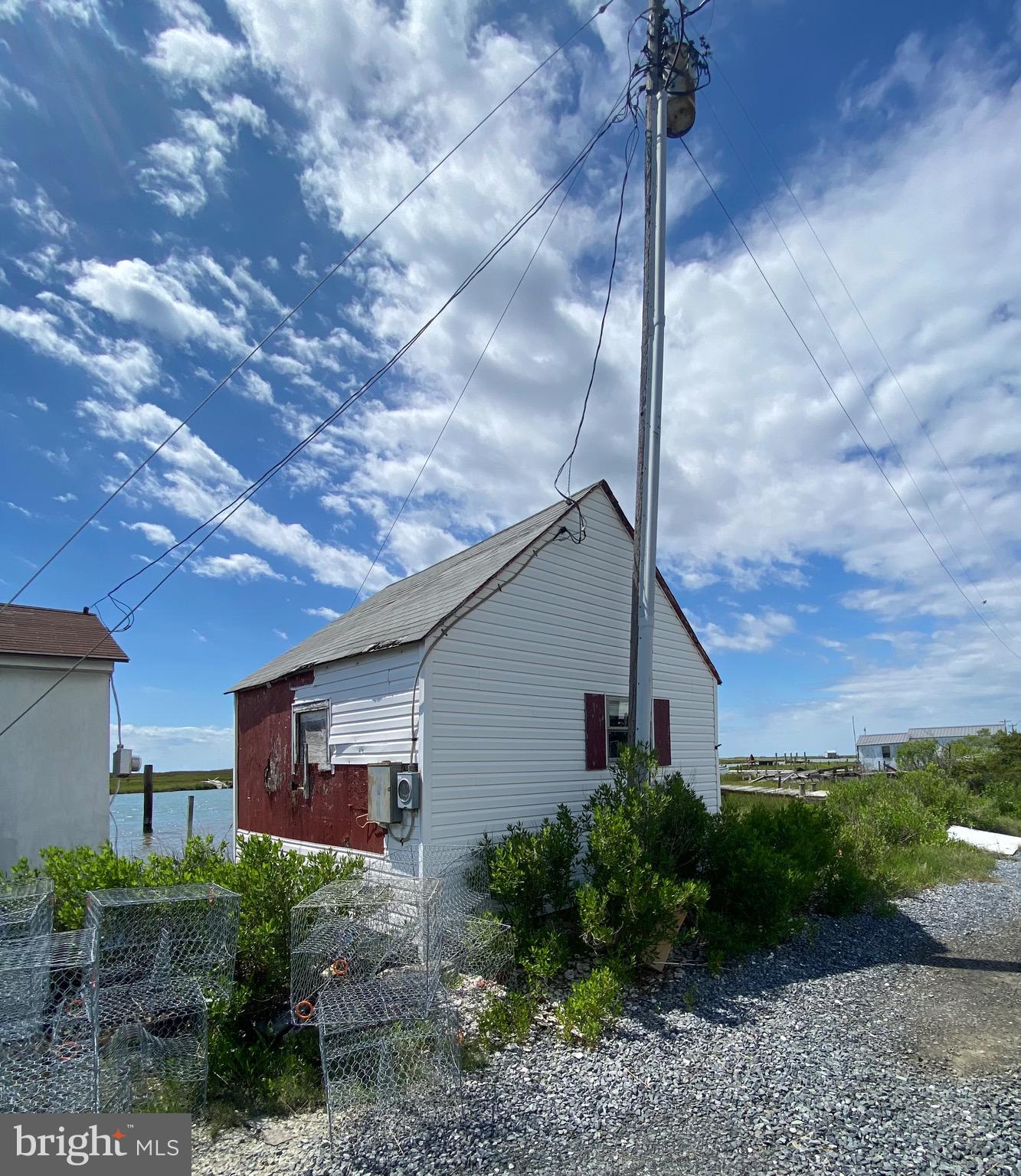 3251 Marsh Road Ewell, MD 21824 - Photo 5 of 23 a view of a house with a yard and plants