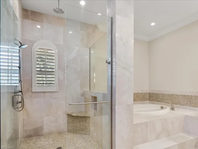 a bathroom with a bathtub and a shower