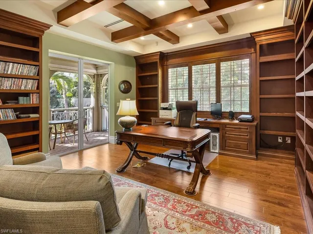 a living room with furniture a table and a large window