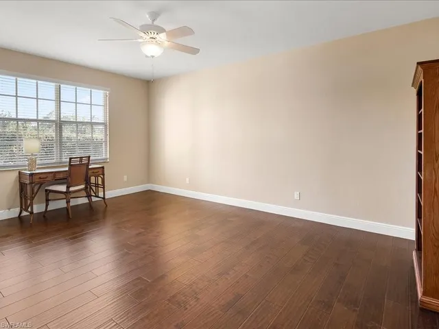 a view of workspace with wooden floor and a window