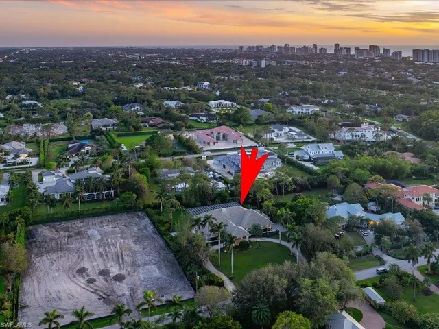 an aerial view of a houses with a street