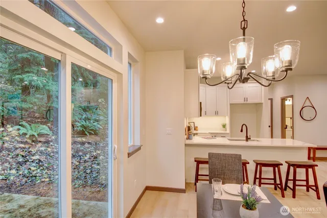 a large kitchen with a table and chairs